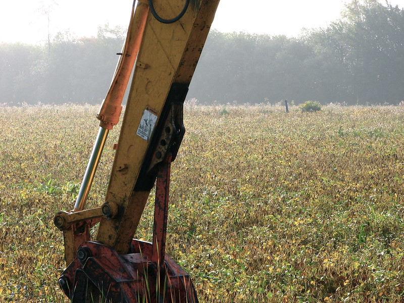 Hydraulic backhoe in a field