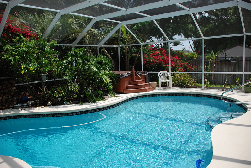 In-ground pool surrounded by a pool enclosure