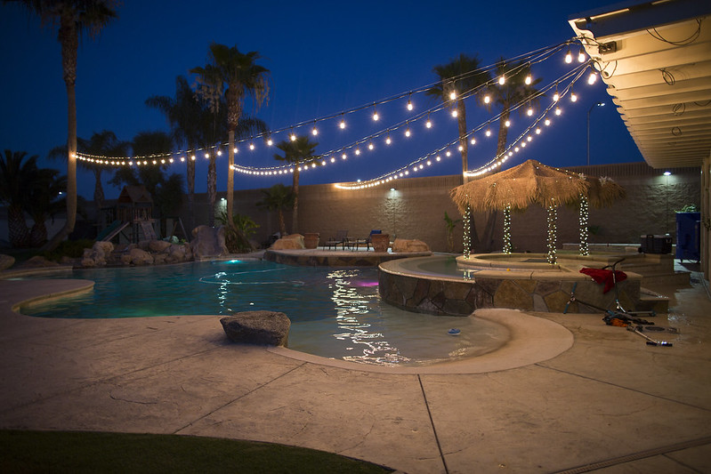 Outdoor lights over a backyard pool
