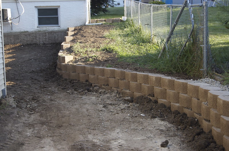 Newly finished retaining wall in a backyard