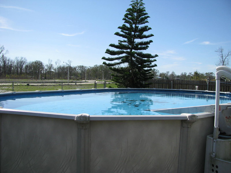 Above-ground pool with a tree in the background