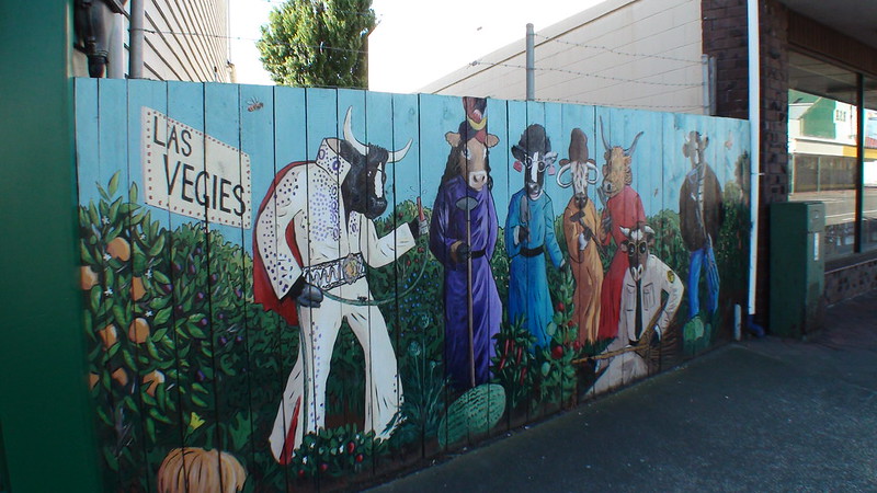 Fence painted with bulls dressed as Las Vegas characters