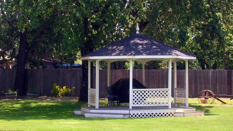 White gazebo in a backyard