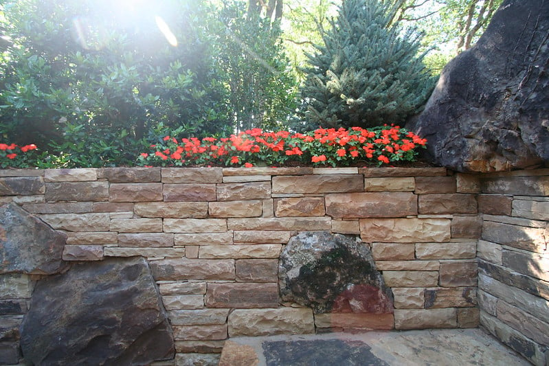 Landscaping on top of a stone retaining wall
