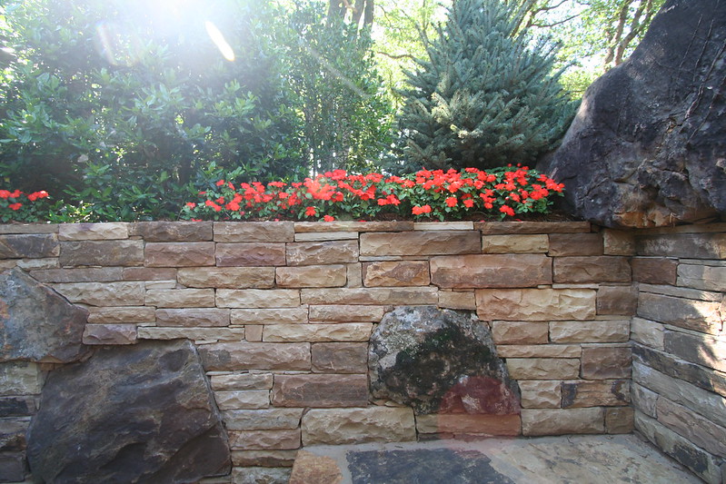 Landscaping on top of a stone retaining wall