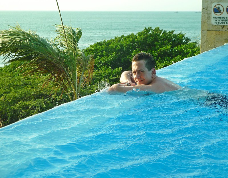 Man leaning on the edge of an infinity pool