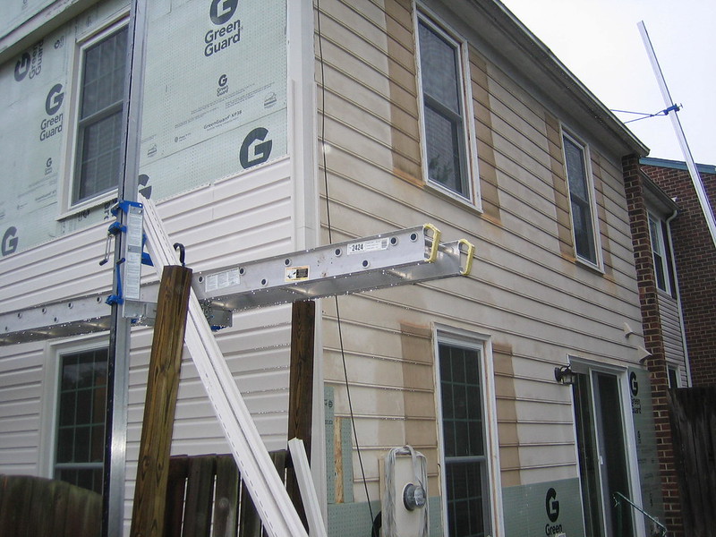 House with most of the siding removed and a portion has been reinstalled
