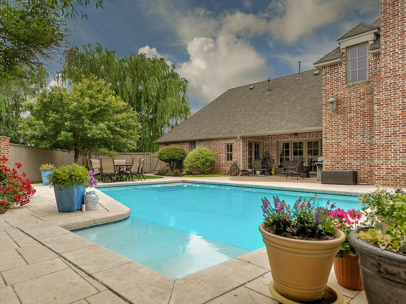 Large backyard pool with a large patio area