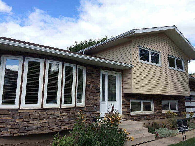 House with vinyl siding and stone