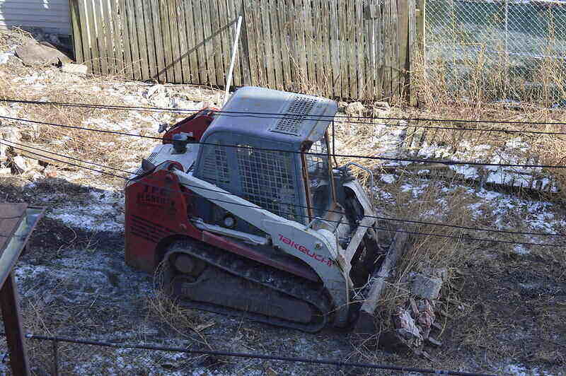 Skid steer clearing brush