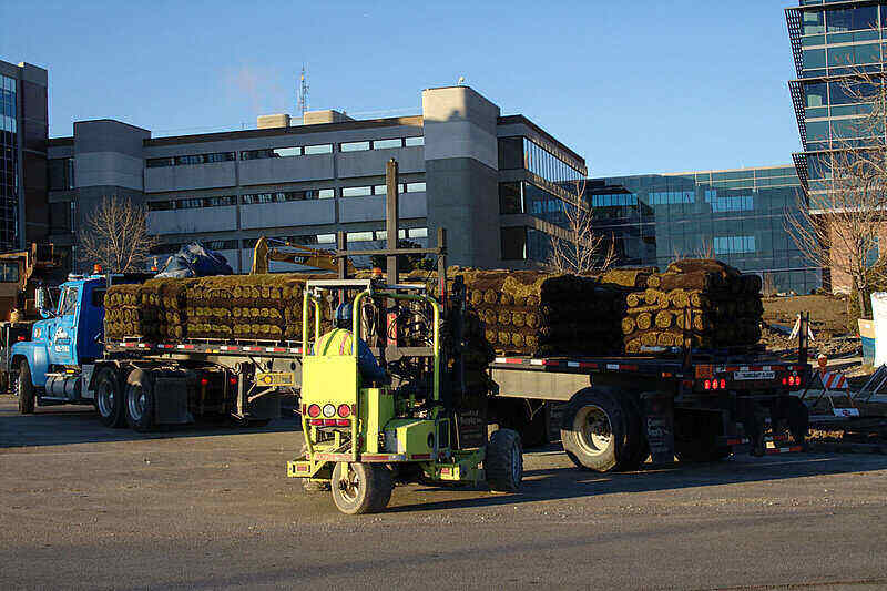 Sod rolls stacked on the bed of a semi for delivery