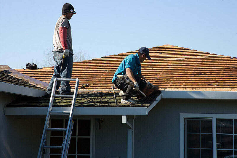 Workers replacing a roof