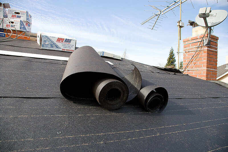 Roll of roofing felt on top of a roof