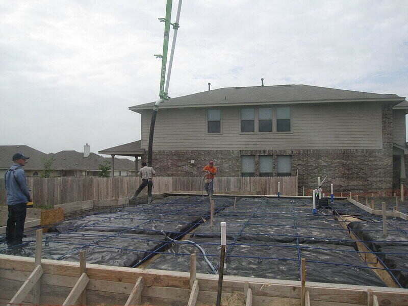 Workers preparing for concrete to be poured for a foundation