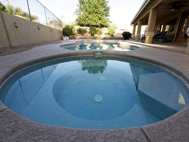 Circular in-grounds pools next to each other