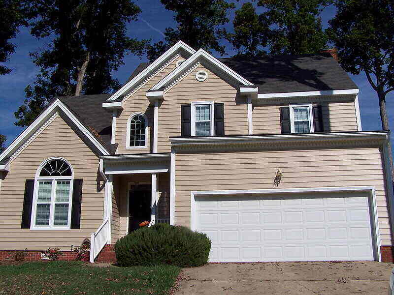 Front-facing picture of a house with tan siding