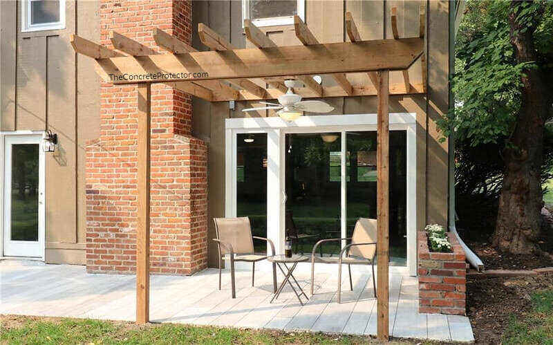 Wood pergola over a patio with bistro set