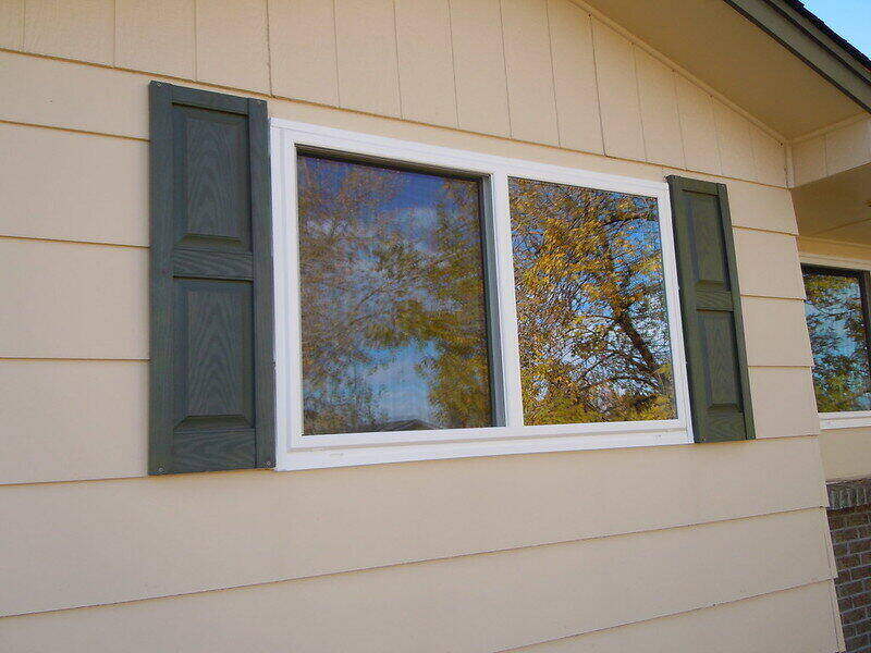 Windows on the side of a house with siding