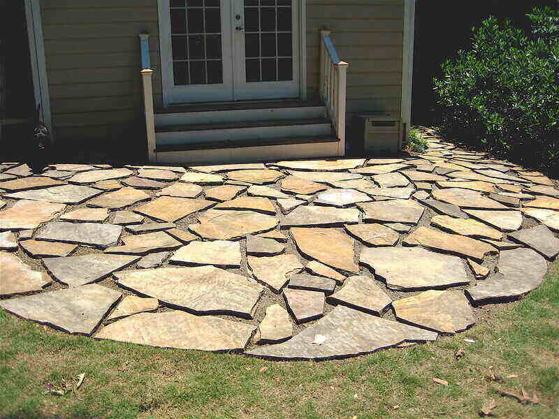 Stone pavers set in front of steps for a patio