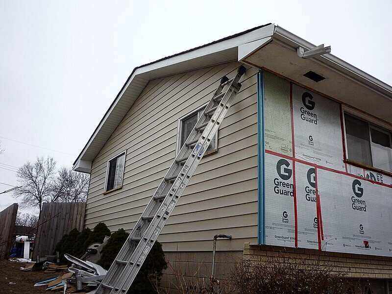 Vinyl siding being installed on a house