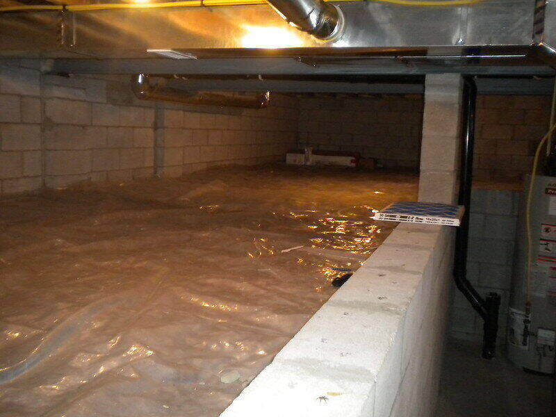 Crawlspace of a house with plastic sheeting