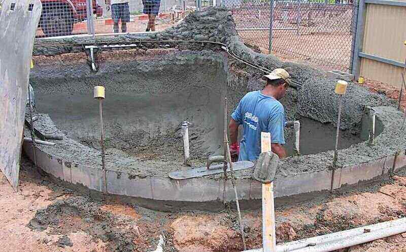 Worker installing a shotcrete pool