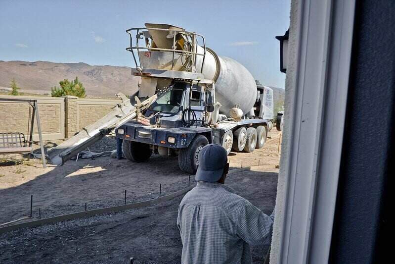 Concrete truck backed up and ready to pour into a prepared area