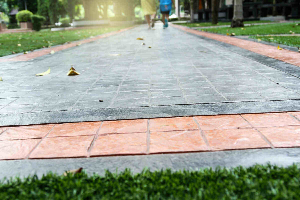 Pricing Guide: How Much Does Stamped Concrete Cost? Image from the ground looking down a walkway