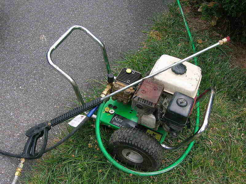 Green gas pressure washer sitting in the grass
