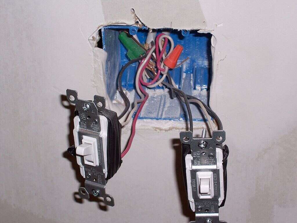double electrical outlet with wires and switches exposed
