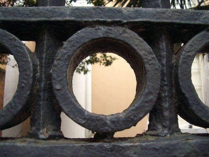 Close-up of a thick circle detail on an iron fence