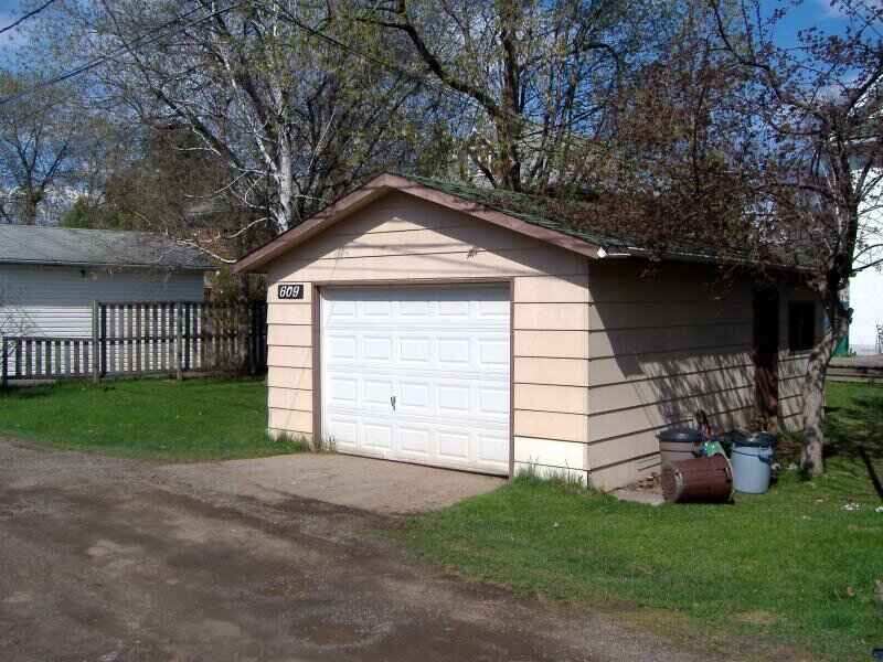 Detached garage with a white garage door