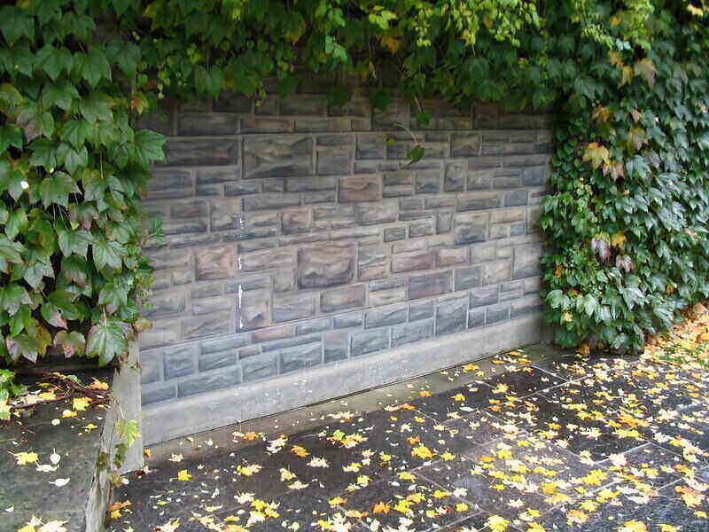 custom garage door with fake stone on the outside of it