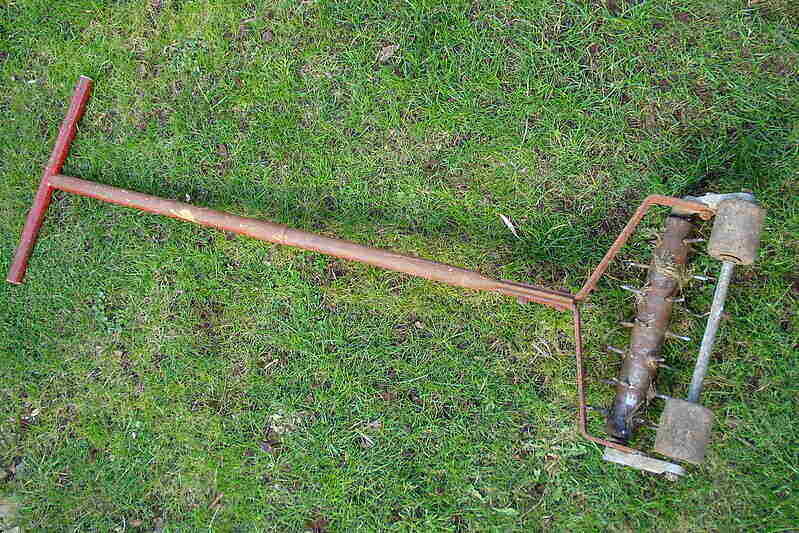 Old manual aerating rake with rollers