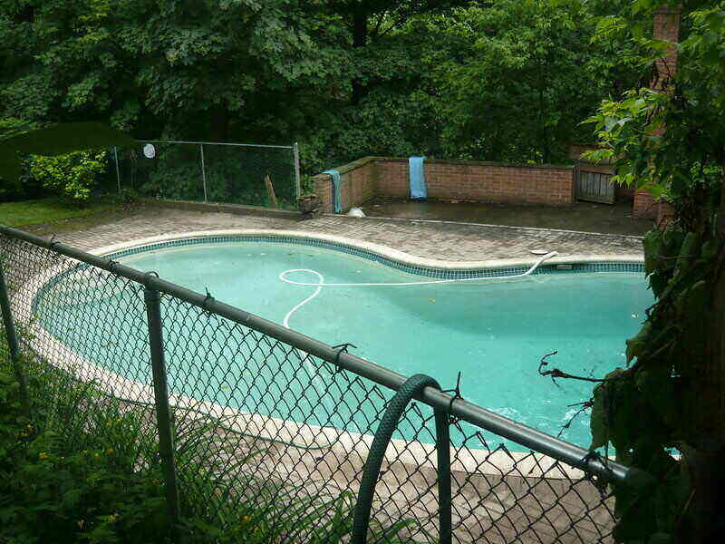 In-ground pool with a fence surrounding the perimeter