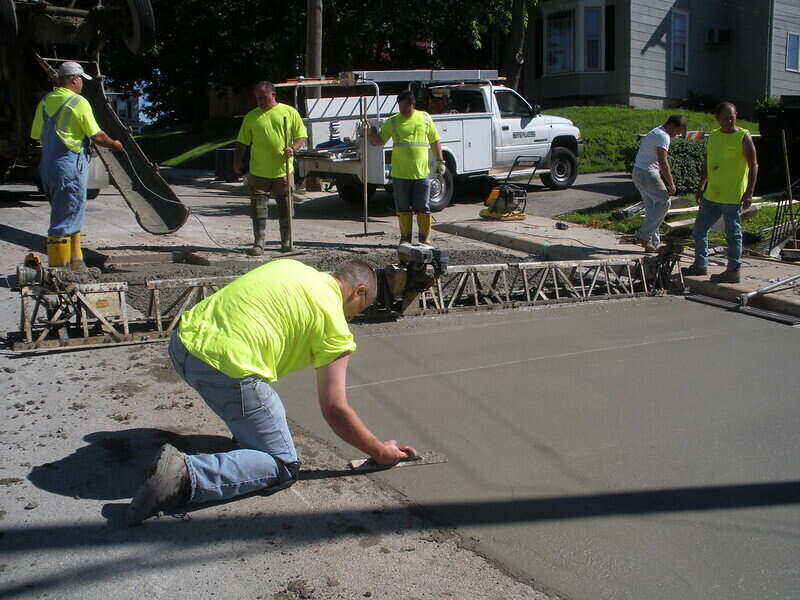 workers smoothing new concrete