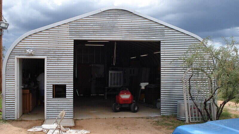 Metal garage with a tractor inside