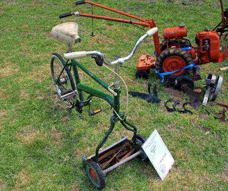 Bicycle with a reel mower attachment where the front tire should be