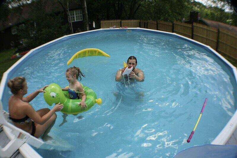 Family playing in an above-ground swimming pool