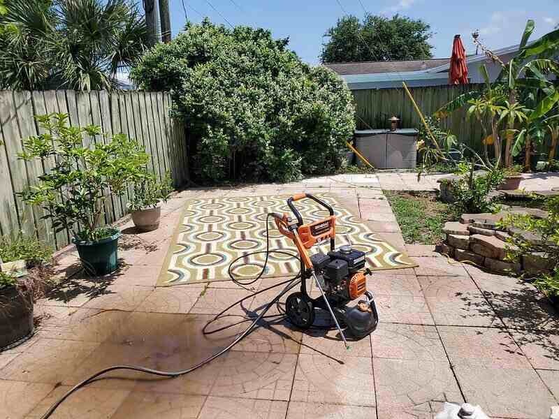 Corded electric pressure washer used for cleaning a large area rug