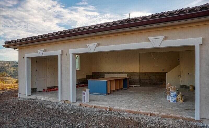 A garage in the process of being built, with the walls built but still need finished