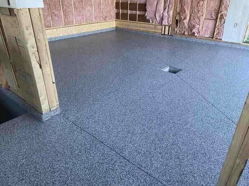 Exposed insulation and new flooring in a garage