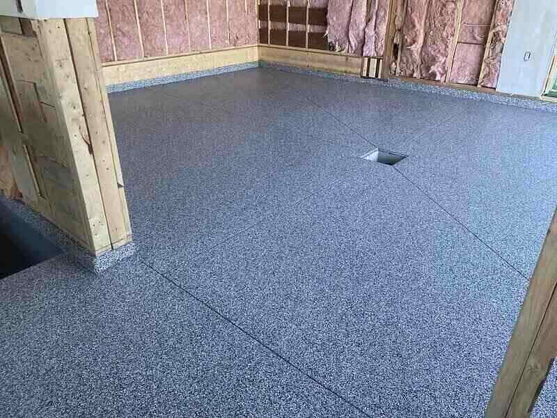Exposed insulation and new flooring in a garage