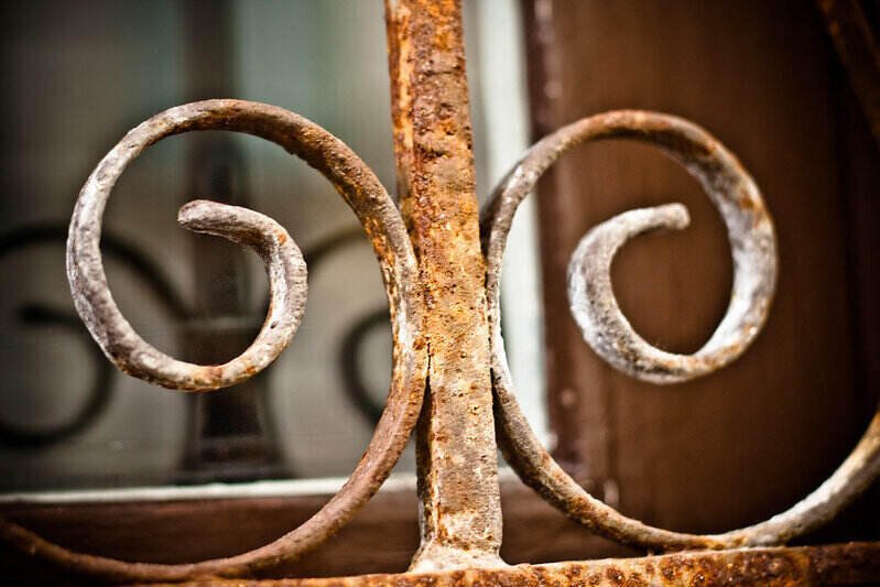 Rusty iron fence with curved detail