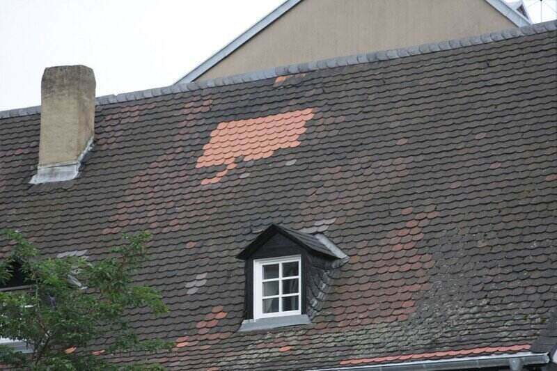 Roof with new shingles replaced in one area