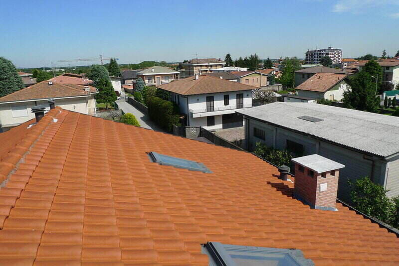 aerial view of various types of roofs in a populated area