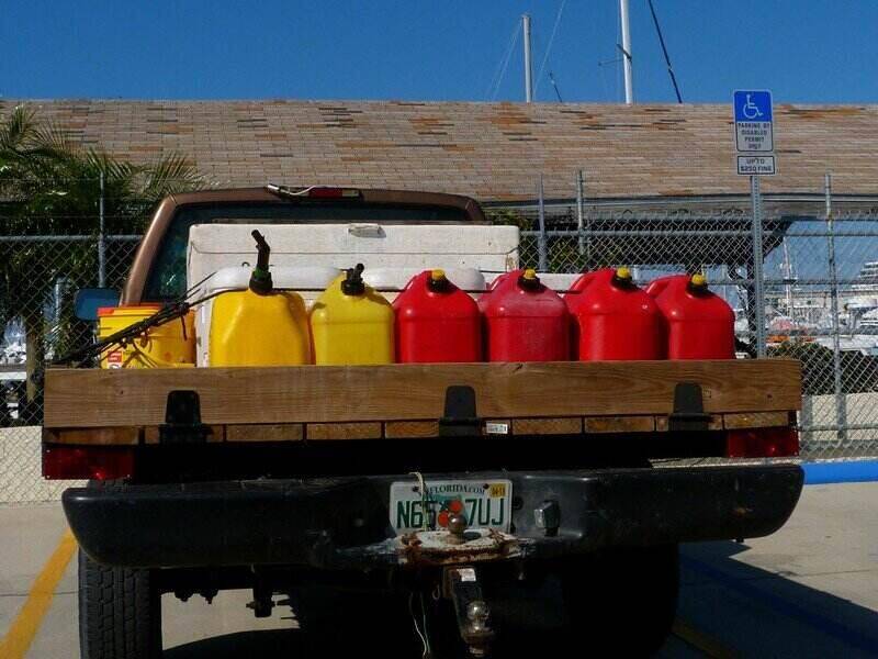 Truck bed full of red and yellow gas cans