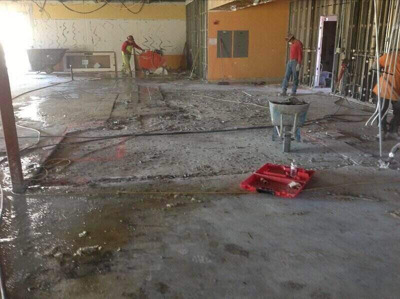 Workers breaking up a concrete floor