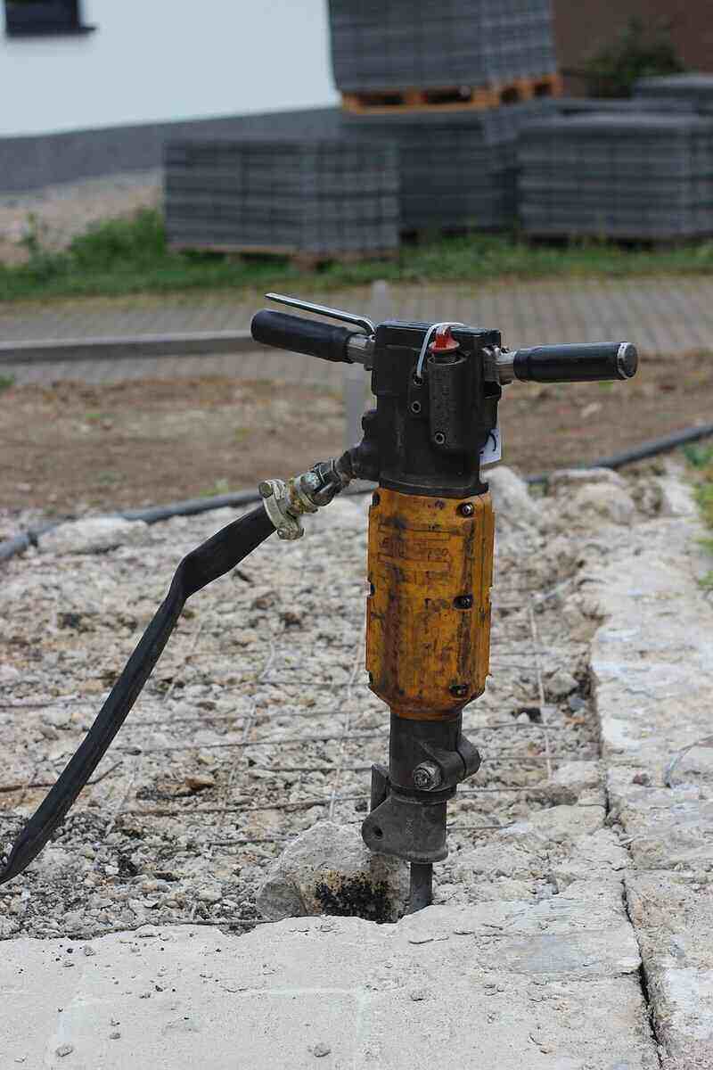Hammer drill sitting idle in a slab of concrete