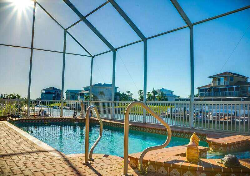 in-ground pool with a screen enclosure surrounding it